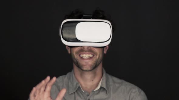 Slow motion shot of man enjoying virtual reality simulator