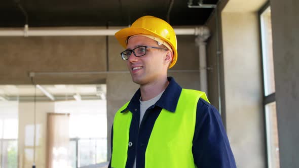 Male Builder in Helmet and Safety West at Office