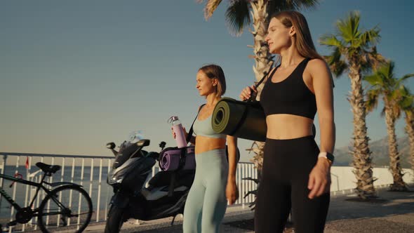 Two Beautiful Girls Jogging at Sunset or Sunrise on Beach