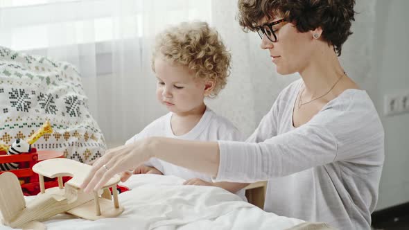 Curly Mother and Toddler Playing Together alt