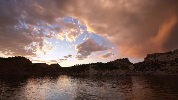 Clouds lit up at sunset over lake in the Utah desert