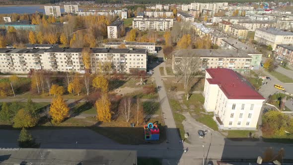 Aerial view of house of culture, alley and pond in a provincial autumn town 24