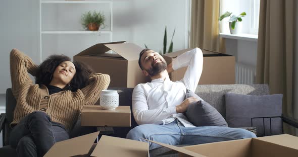 Multiethnic Couple Afro American Girl Wife and Caucasian Man Husband Sitting on Sofa in Living Room