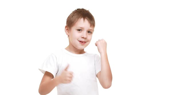 Young Caucasian Boy Happily Moving Hands and Showing Ok at Camera with Big Smile