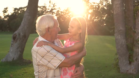 Conversation Between Grandpa and Granddaughter Outdoors.