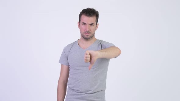 Young Sad Hispanic Man Giving Thumbs Down