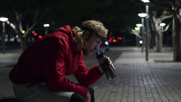 Sporty Caucasian man drinking water