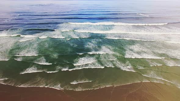 Aerial view of waves reaching a shore at beach