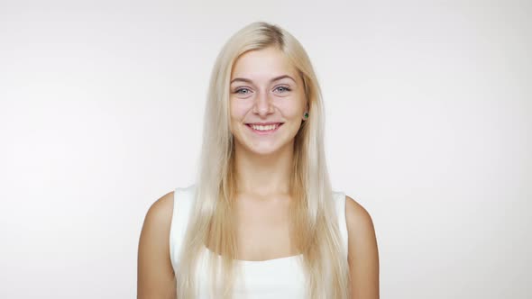 Cheerful Blondie Woman Laughing Welcoming Waving Hand Saying "Hi" on Camera Over White Background