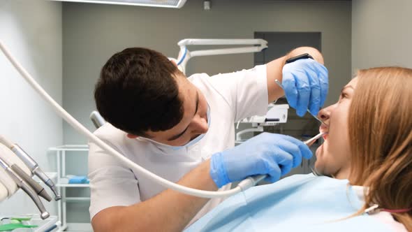 Beautiful Young Woman Checking Teeth in the Dentist's Office