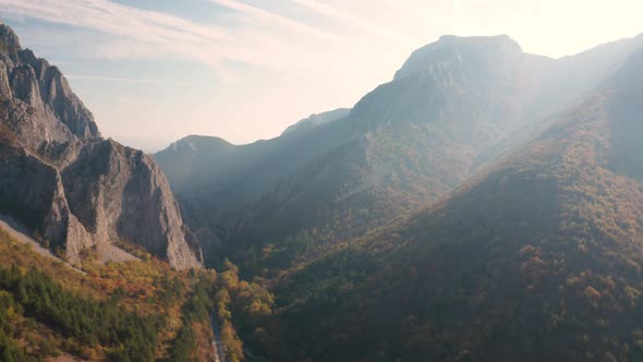 Drone flight over autumn rocky mountain in the morning light