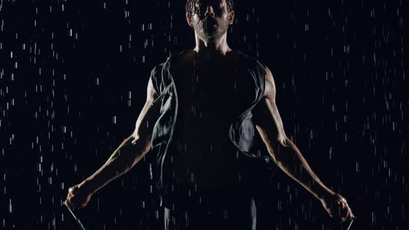 Athletic Man Jumping Rope In The Rain