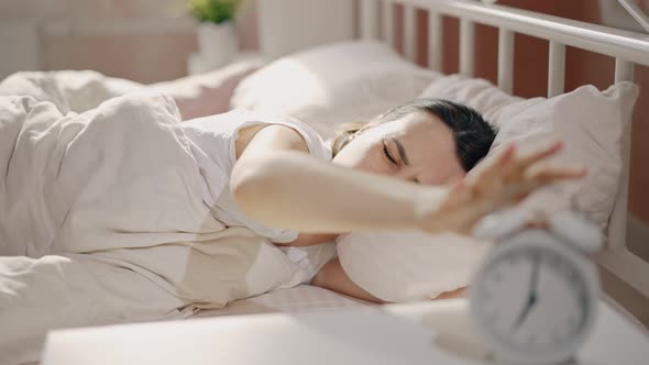 Dissatisfied Woman Wakes Up From the Alarm Clock and Sleeps on