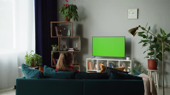 Woman Watching Television with Green Screen