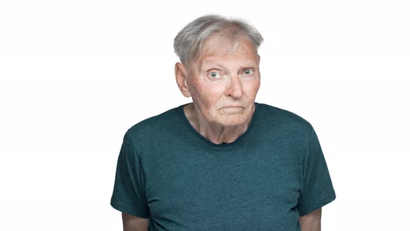 Portrait of Serious Old Aged Man 80s Having Gray Hair in Basic Tshirt Grimacing and Looking at