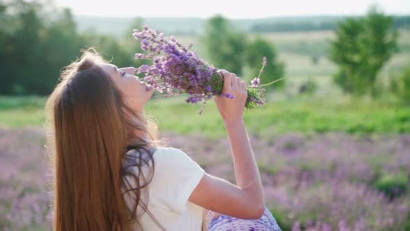 Happy Girl Collecting Lavender Flowers in Field