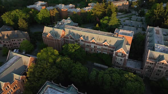 Orbiting aerial of the University of Washington's Communication building during golden hour.