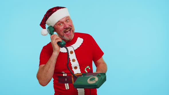 Funny Man in Christmas Tshirt Talking on Wired Vintage Telephone of 80s Says Hey you Call Me Back