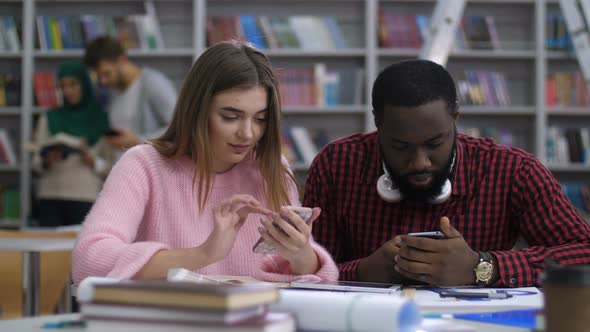 Diverse Students Sharing Online Content on Phone