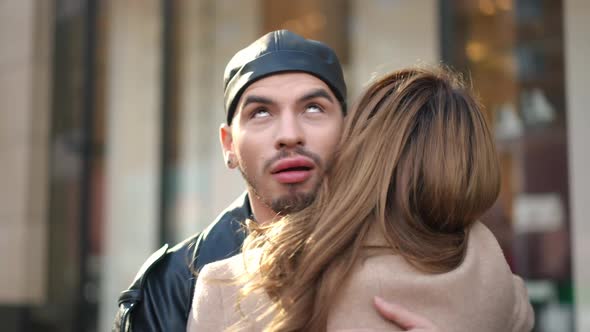 Hypocritical Gay Man Hugging Friend Rolling Eyes Smiling