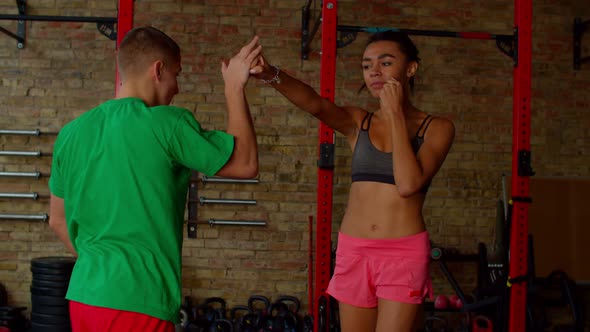 Active Fit Black Woman Boxer Improving Boxing Technique with Trainer at Gym