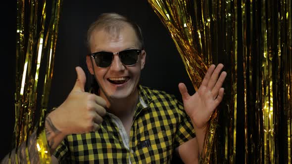 Portrait of Caucasian Man Posing on Black Background. Gold Shining Foil Strips. Party, Music, Disco