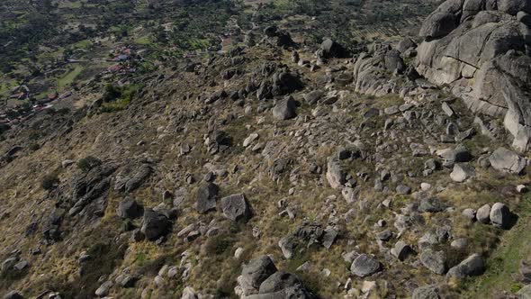 Camera highlights the rugged terrain of the region surrounding Monsanto Castle; the isolated castle