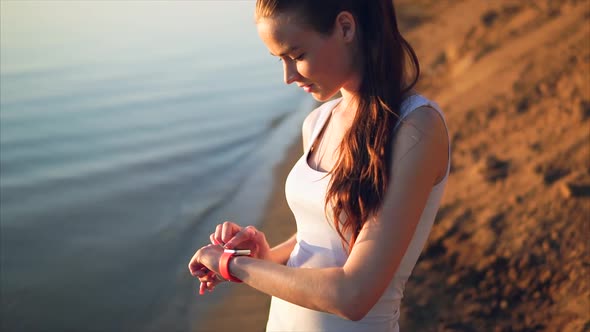 Young Attractive Woman Using Touchscreen Smart Watches