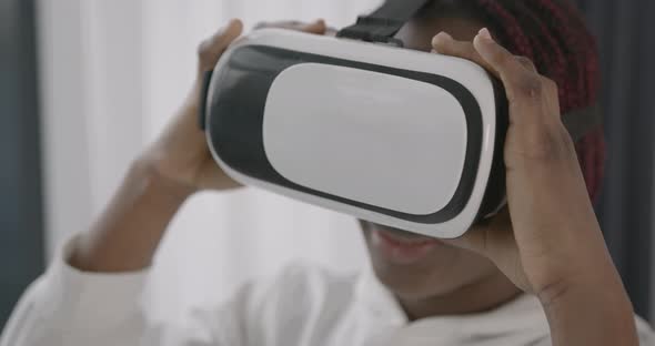 Young Girl in VR Glasses at Home