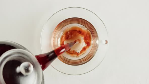 Pouring Black Tea in Cup Top View