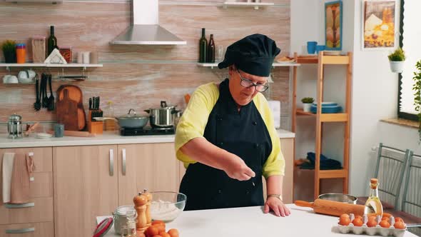 Adding Flour on Table By Hand