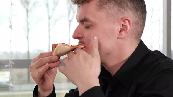 Guy with Appetite Eats Pizza