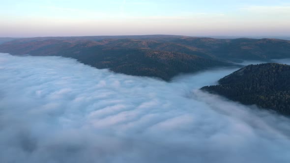 Aerial Hyperlapse of Mist Flow in a Mountain Gorge at Dawn