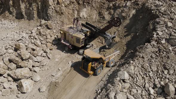 Heavy Equipment Loads Limestone Into The Machine 