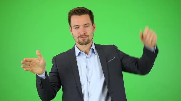 A Man Goes Through a List of Files, Then Pulls Out a Picture or a File and Holds It Out for Camera