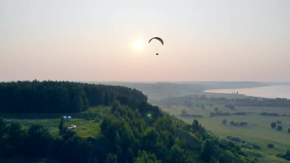 Foggy Fields with the Paraglider Floating Over Them