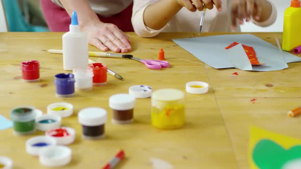 Close Up of Hands of Kids Painting and Making Paper Crafts in Art Class alt