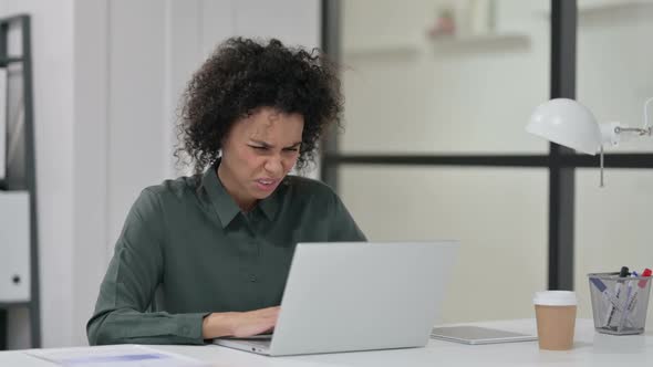 African Woman Feeling Disappointed While Using Laptop