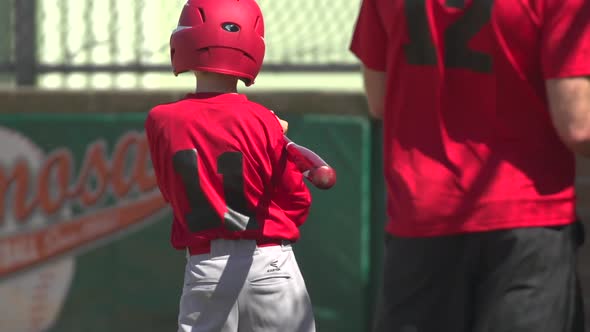 Kids playing little league baseball.