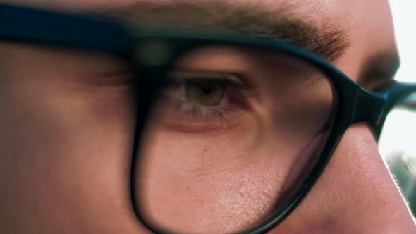 Close-up of a focused look of a young man in glasses for vision	