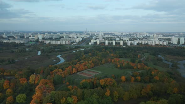 Flight over the autumn park. Trees with yellow autumn leaves are visible. Aerial photography.