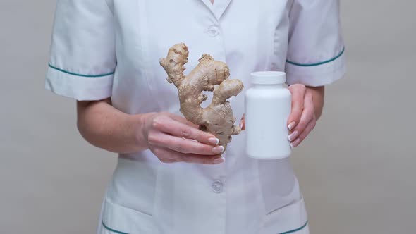 Nutritionist Doctor Healthy Lifestyle Concept - Holding Ginger Root and Jar of or Vitamine Pills