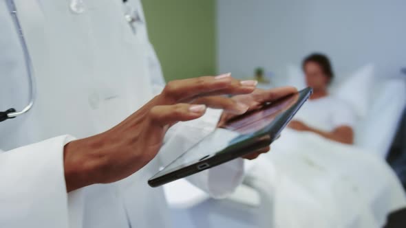 Close-up of African american female doctor using digital tablet in ward at hospital