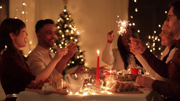 Happy Friends Having Christmas Dinner at Home