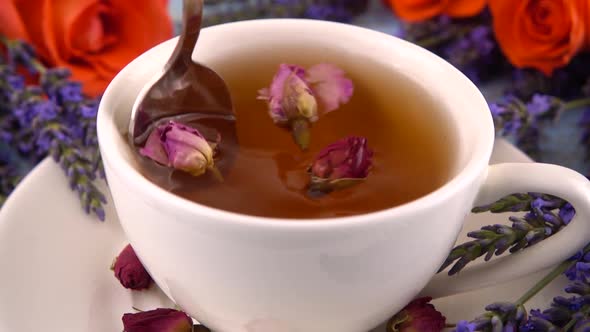 Provencal style composition: tea with fragrant rose buds, fresh rose flowers and lavender 