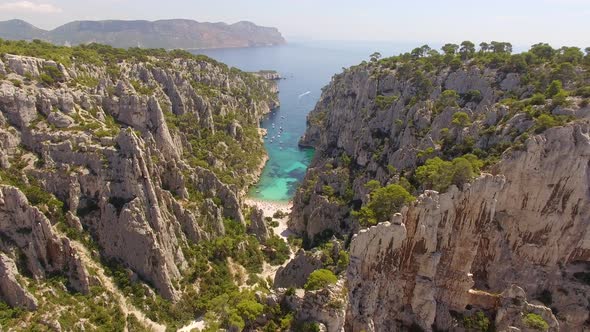 Aerial travel drone view of clear green water, cliffs of Cassis, Mediterranean Sea, Southern France.