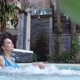 Beautiful Young Woman Relaxes in a Hydromassage Jacuzzi in Swimming Pool - VideoHive Item for Sale