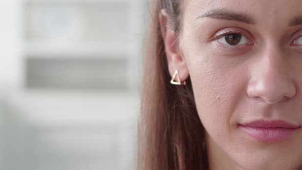 Young Woman Half Face with Brown Hair and Radiant Face with Perfect Skin