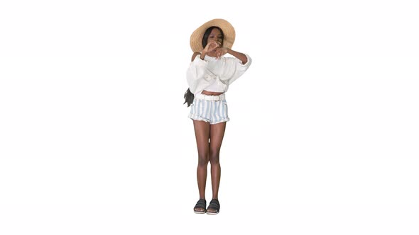 Cheerful African American Girl in a Straw Hat Dancing on White Background