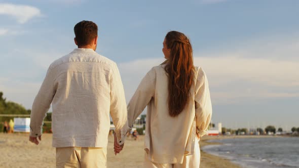 Happy Couple Walking Along Summer Beach